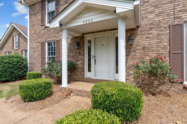 a view of an entryway with wooden floor and stairs
