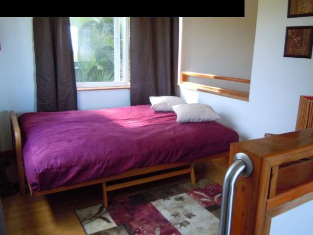 646 Awalau Road Haiku, HI 96708 - Photo 20 of 28 a bedroom with a bed and a window