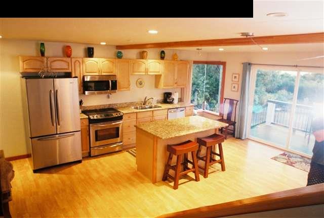 646 Awalau Road Haiku, HI 96708 - Photo 5 of 28 a kitchen with stainless steel appliances granite countertop a sink and a refrigerator