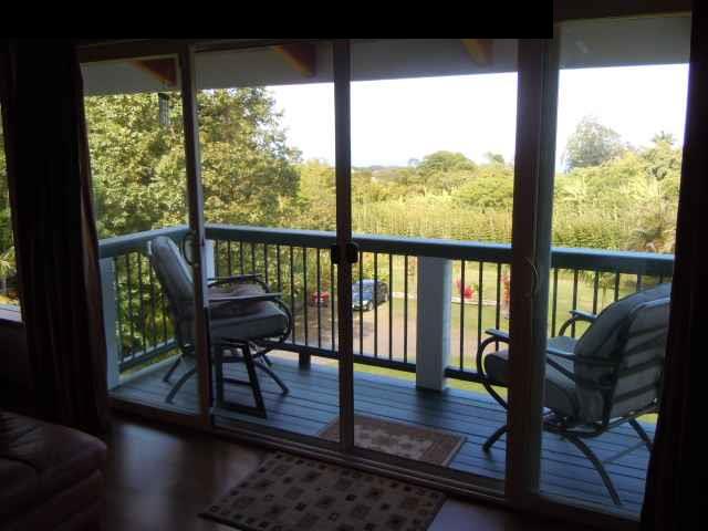 646 Awalau Road Haiku, HI 96708 - Photo 9 of 28 a view of a living room and floor to ceiling window wooden floor