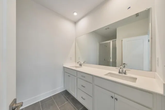 a bathroom with 2 sink a mirror and a vanity