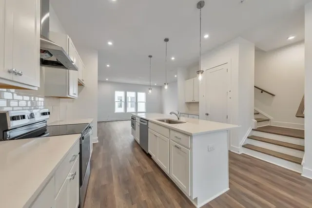 a kitchen with a stove a sink and a refrigerator