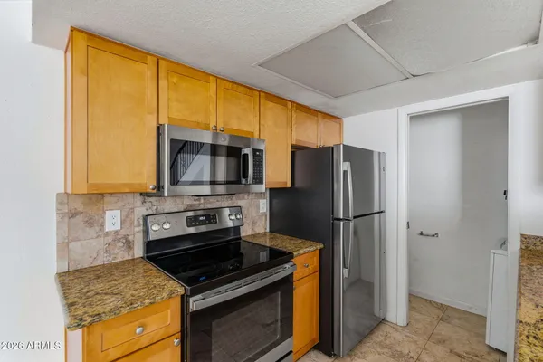 a kitchen with a stove a refrigerator and a sink