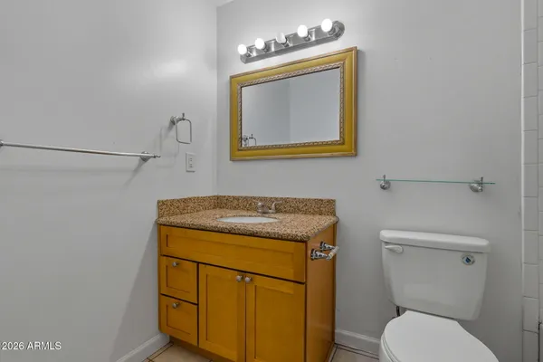 a bathroom with a toilet sink and mirror