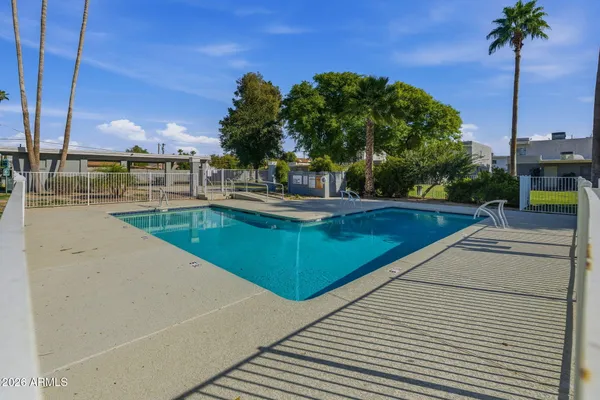 a view of a swimming pool with a lounge chairs