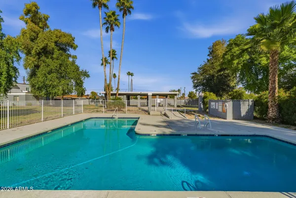 a view of a swimming pool with an outdoor seating and a garden