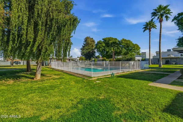 a view of a backyard with swimming pool