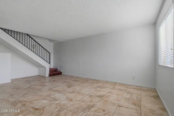 a view of an empty room with stairs