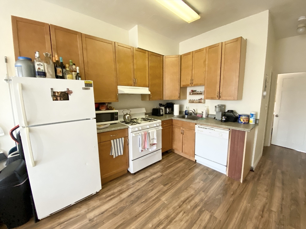 96 Hammond Street, Unit 3 Boston, MA 02120 - Photo 2 of 8 a kitchen with white cabinets and white appliances