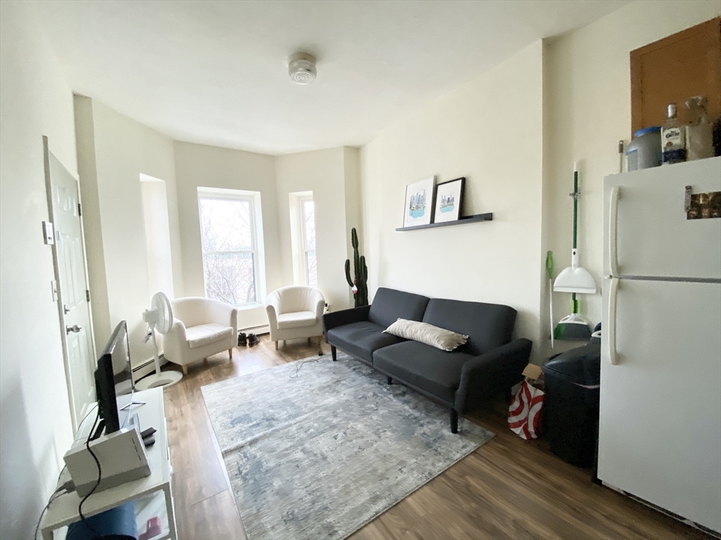 96 Hammond Street, Unit 3 Boston, MA 02120 - Photo 3 of 8 a living room with furniture and a window