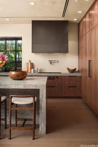a kitchen with a sink cabinets and a wooden floor