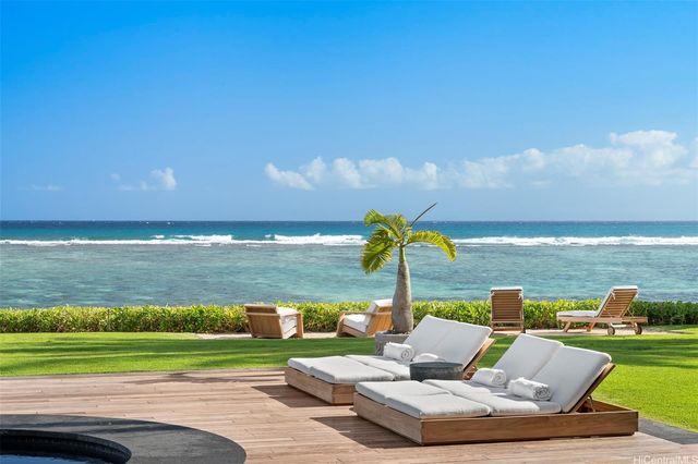 a view of a lake with couches in front of house
