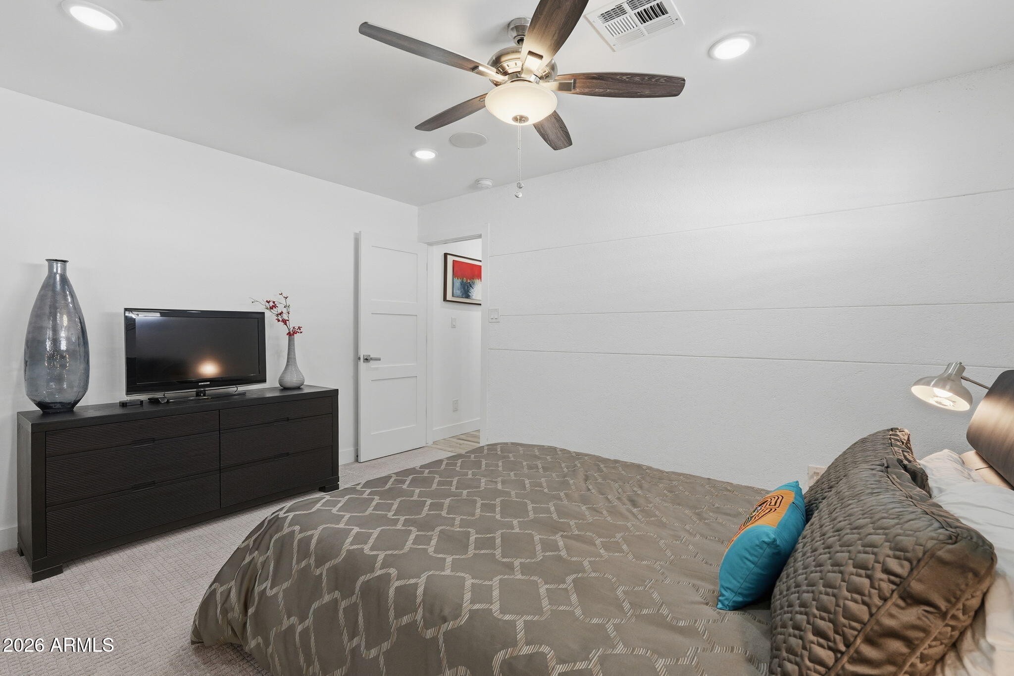 5149 North 34th Street Phoenix, AZ 85018 - Photo 46 of 70 a bedroom with a bed and a flat screen tv