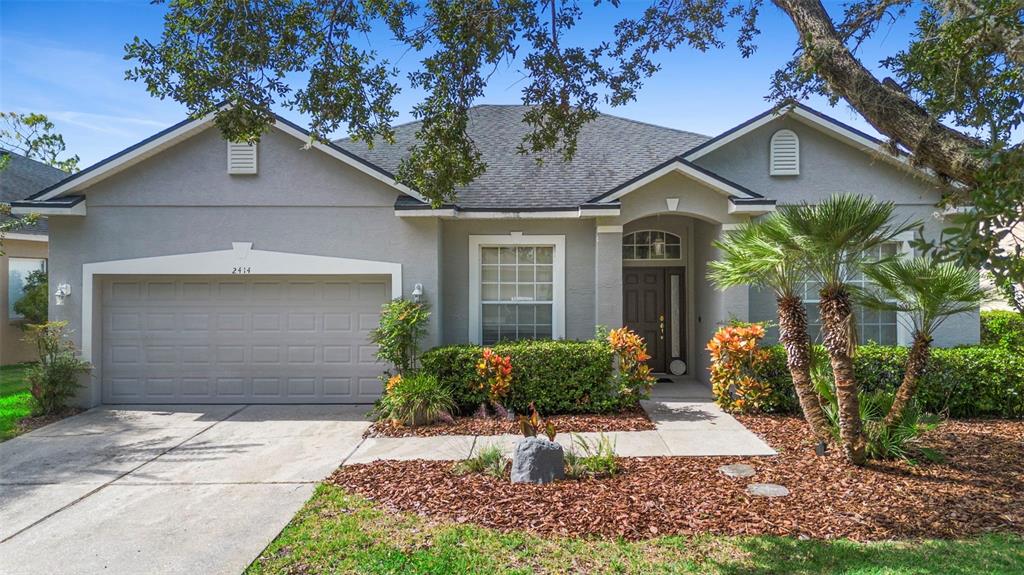 2414 Ridgemoor Drive Orlando, FL 32828 - Photo 1 of 45 a front view of a house with garden