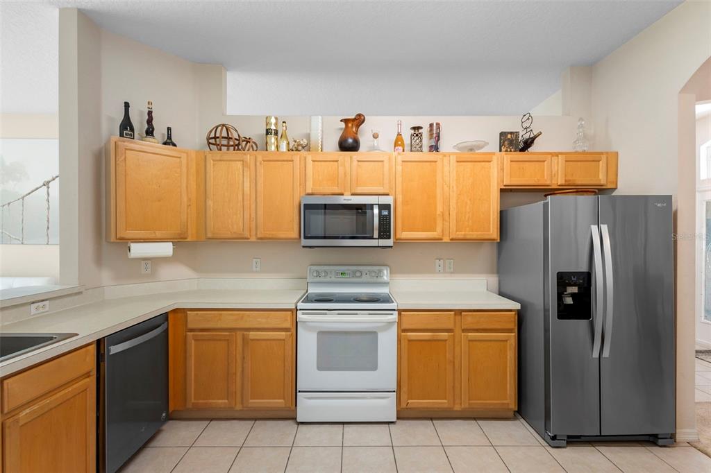 2414 Ridgemoor Drive Orlando, FL 32828 - Photo 16 of 45 a kitchen with stainless steel appliances granite countertop a refrigerator and a stove