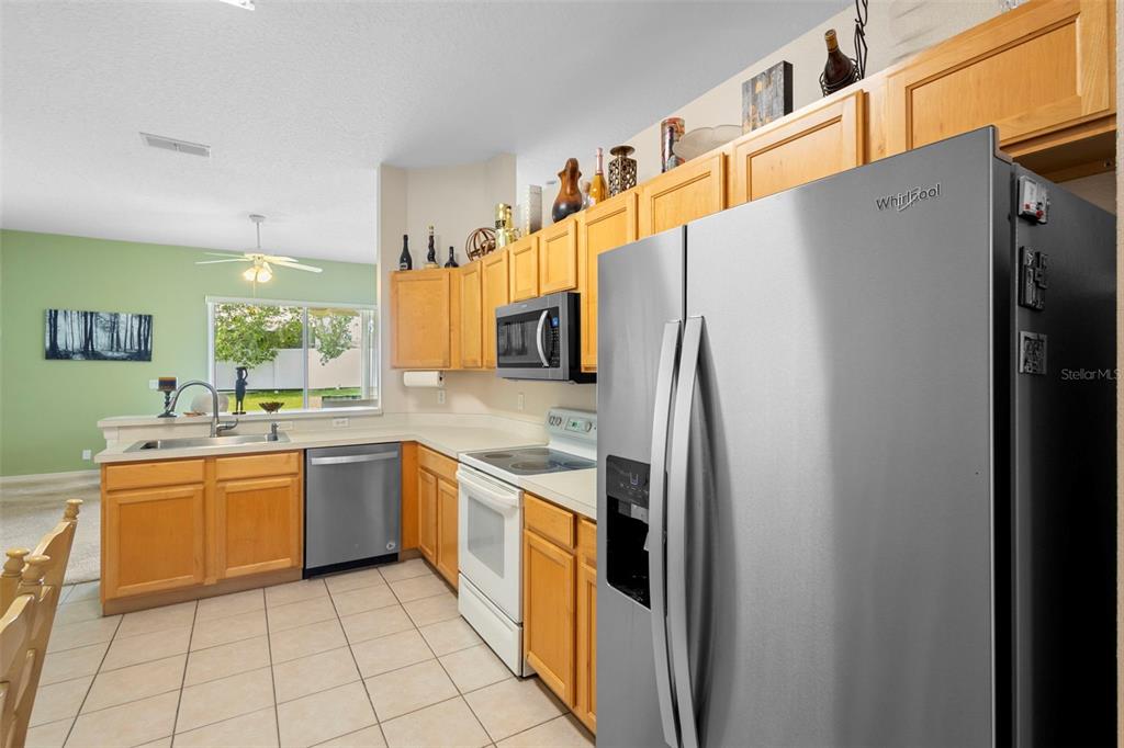 2414 Ridgemoor Drive Orlando, FL 32828 - Photo 17 of 45 a kitchen with stainless steel appliances granite countertop a refrigerator and a sink