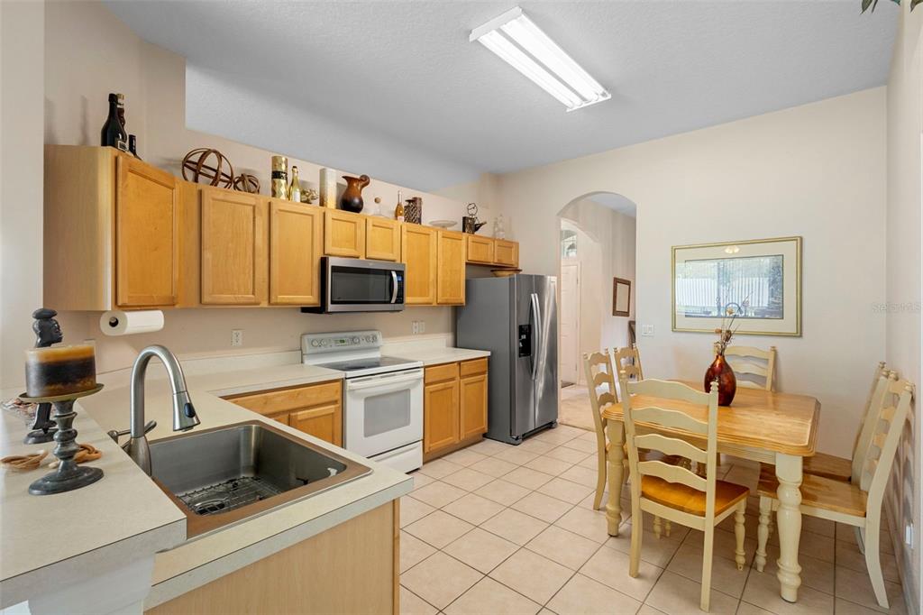 2414 Ridgemoor Drive Orlando, FL 32828 - Photo 18 of 45 a kitchen with a sink cabinets and appliances