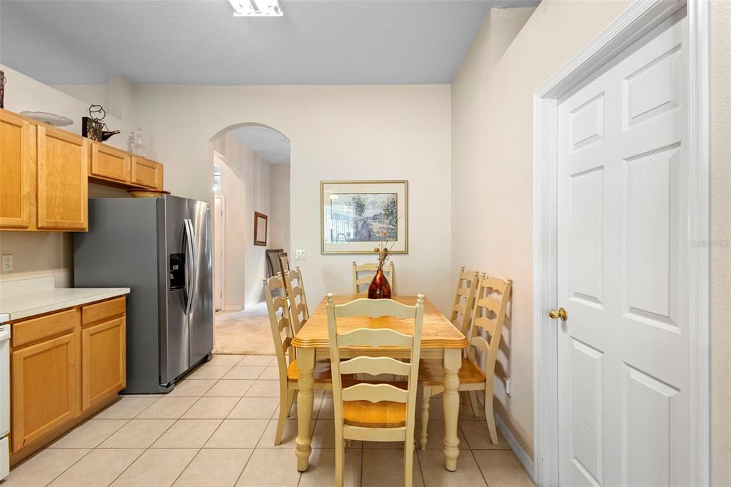 2414 Ridgemoor Drive Orlando, FL 32828 - Photo 19 of 45 a view of a dining room with furniture a rug and wooden floor