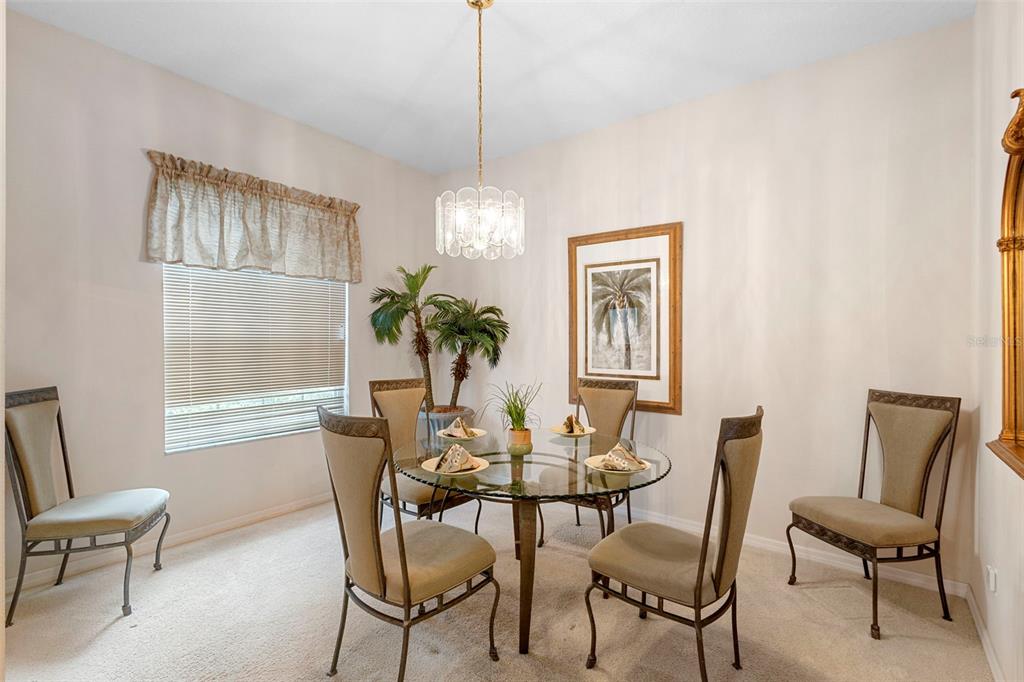 2414 Ridgemoor Drive Orlando, FL 32828 - Photo 23 of 45 a dining room with furniture a chandelier and window
