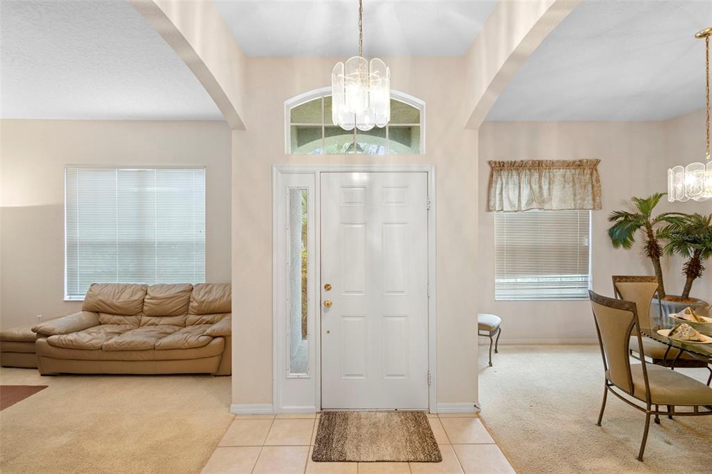 2414 Ridgemoor Drive Orlando, FL 32828 - Photo 25 of 45 a living room with furniture and a chandelier