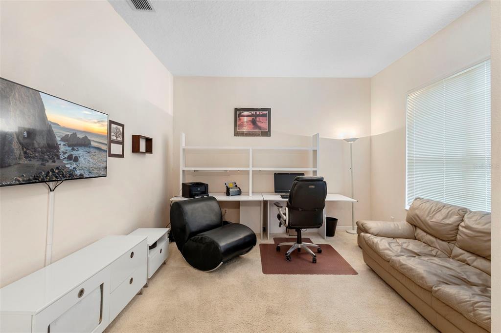 2414 Ridgemoor Drive Orlando, FL 32828 - Photo 26 of 45 a livingroom with workspace and a couch