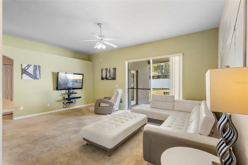 2414 Ridgemoor Drive Orlando, FL 32828 - Photo 30 of 45 a living room with furniture and a flat screen tv