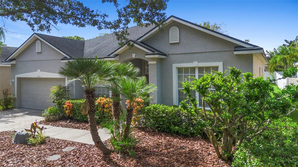 2414 Ridgemoor Drive Orlando, FL 32828 - Photo 3 of 45 a view of a house with a yard and plants