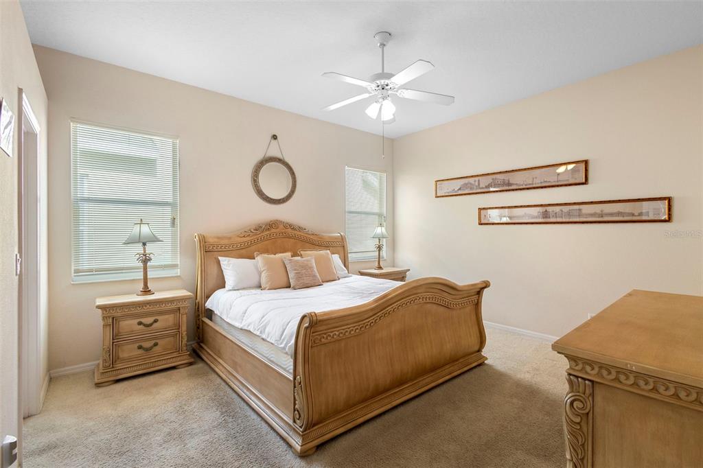 2414 Ridgemoor Drive Orlando, FL 32828 - Photo 32 of 45 a bedroom with a bed and a chandelier