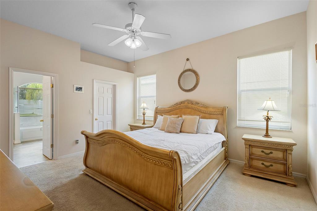 2414 Ridgemoor Drive Orlando, FL 32828 - Photo 33 of 45 a bedroom with a bed and a chandelier