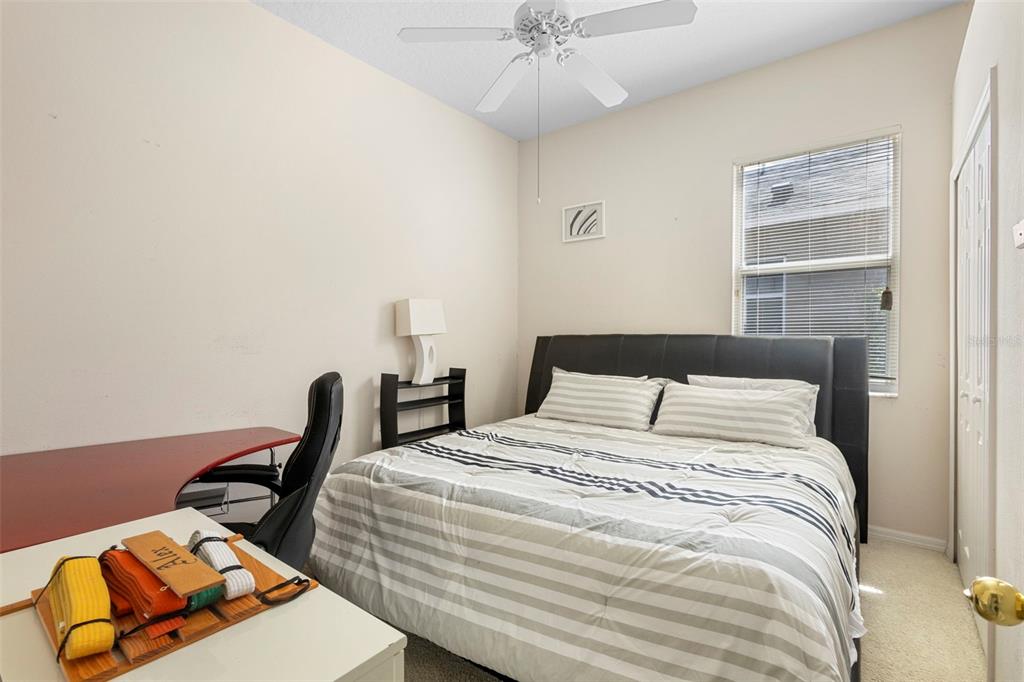 2414 Ridgemoor Drive Orlando, FL 32828 - Photo 36 of 45 a bedroom with a bed and window