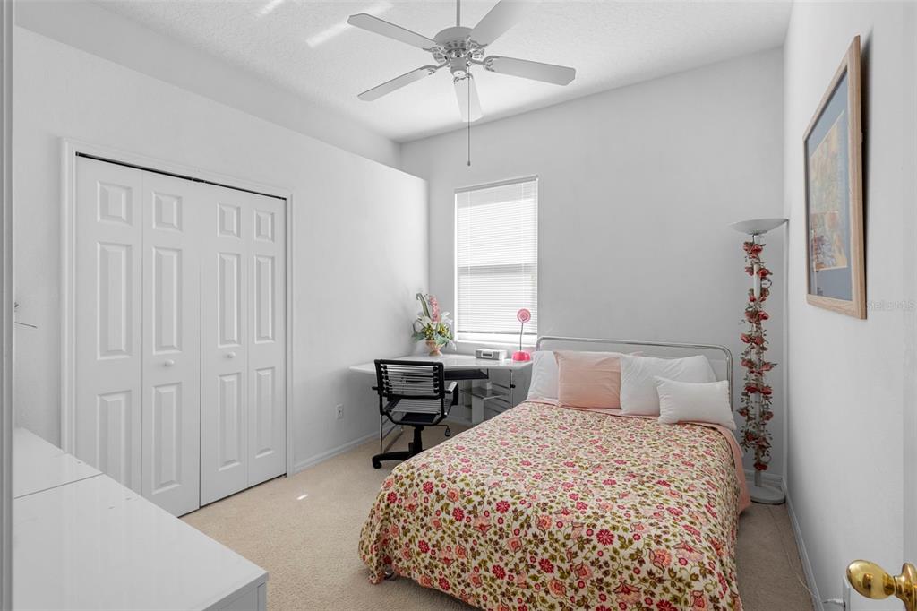 2414 Ridgemoor Drive Orlando, FL 32828 - Photo 37 of 45 a bedroom with a bed and a chandelier