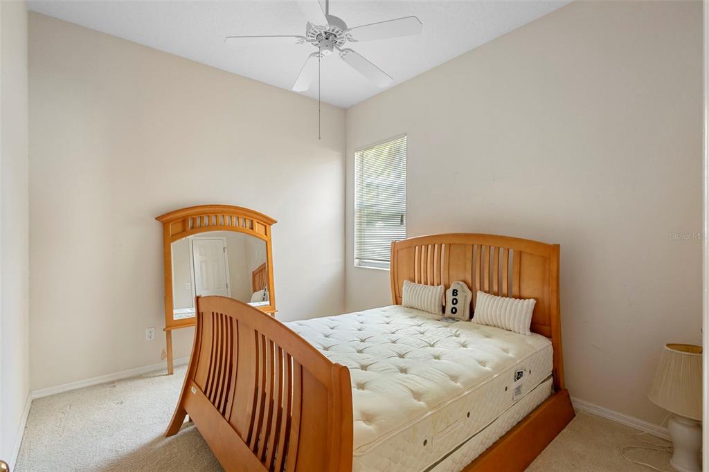 2414 Ridgemoor Drive Orlando, FL 32828 - Photo 38 of 45 a bedroom with a bed and a chandelier