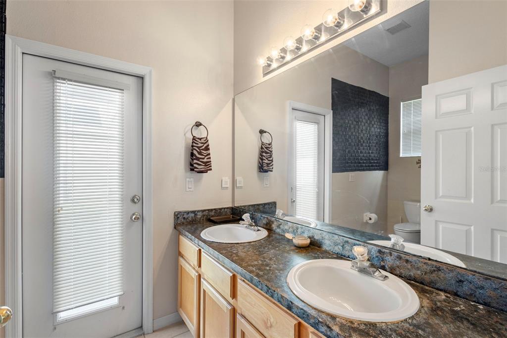2414 Ridgemoor Drive Orlando, FL 32828 - Photo 39 of 45 a bathroom with a granite countertop sink and a mirror