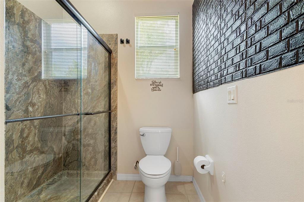 2414 Ridgemoor Drive Orlando, FL 32828 - Photo 40 of 45 a bathroom with a toilet and a shower