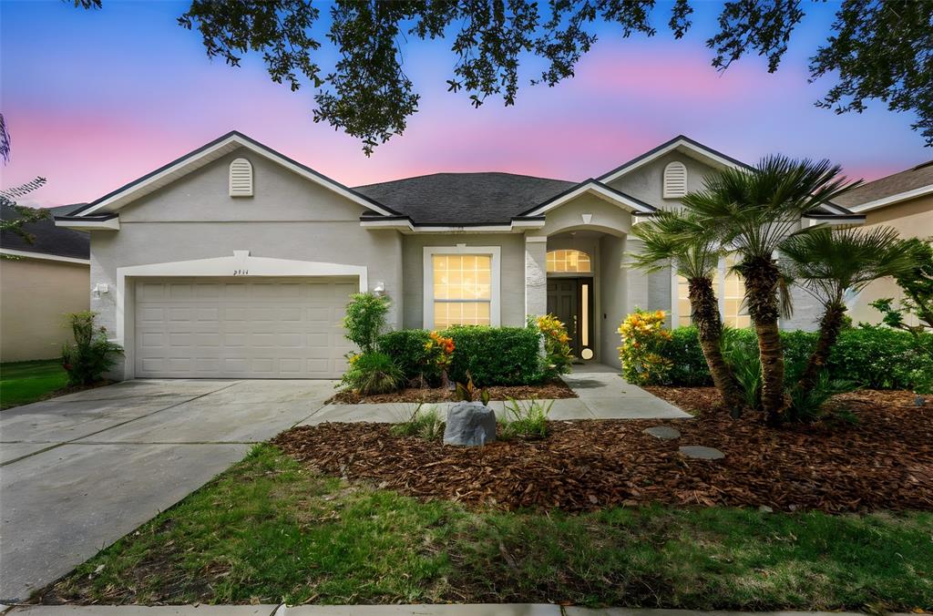 2414 Ridgemoor Drive Orlando, FL 32828 - Photo 44 of 45 a front view of a house with a yard and garage