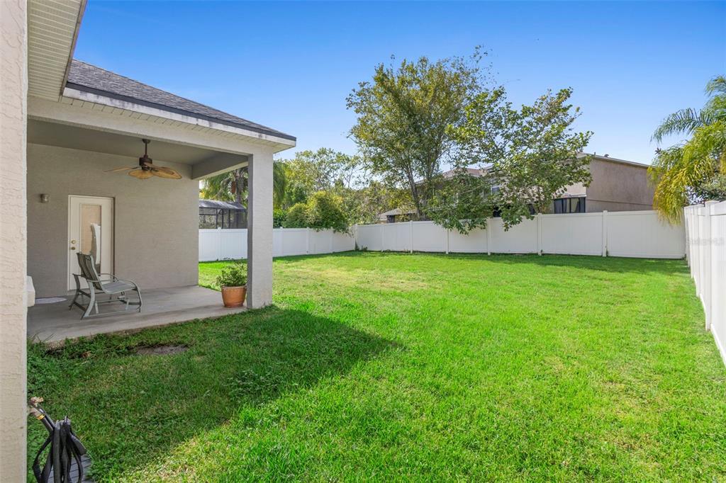 2414 Ridgemoor Drive Orlando, FL 32828 - Photo 7 of 45 a view of a chair and table in backyard