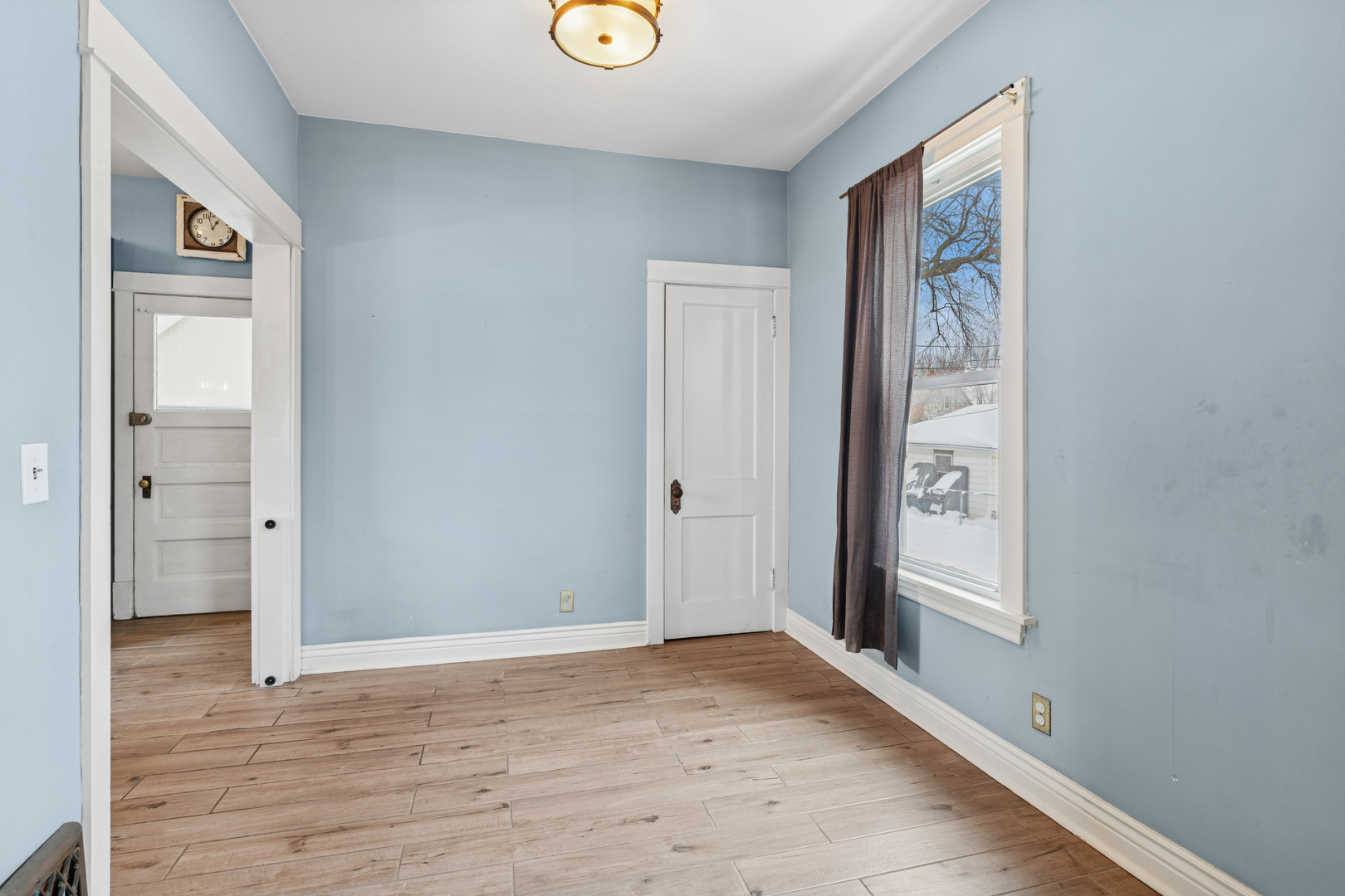 5218 West Patterson Avenue Chicago, IL 60641 - Photo 8 of 29 a view of an empty room with wooden floor and a window