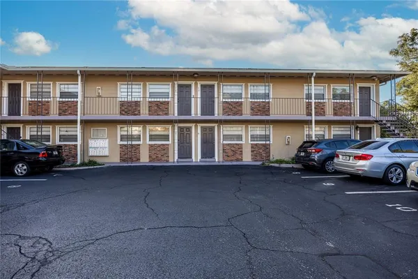a couple of cars parked in front of a building