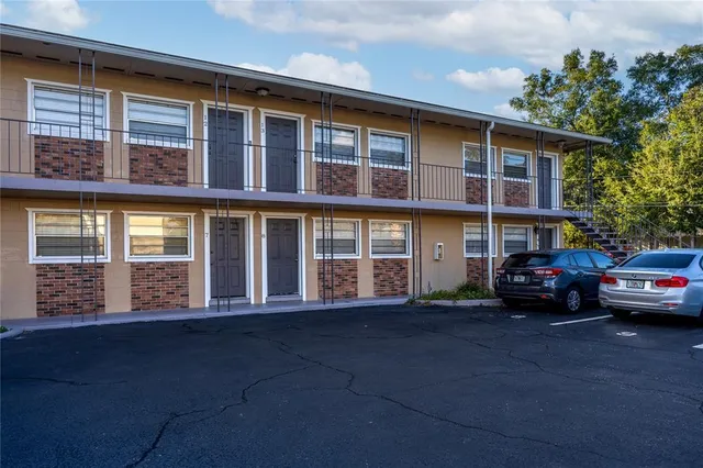 a couple of cars parked in front of a building