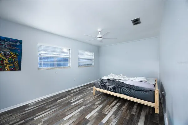 a bedroom with a bed and a window