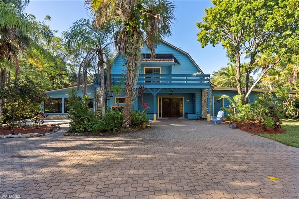 3550 Hazel Road Naples, FL 34104 - Photo 1 of 43 a front view of a house with yard and trees