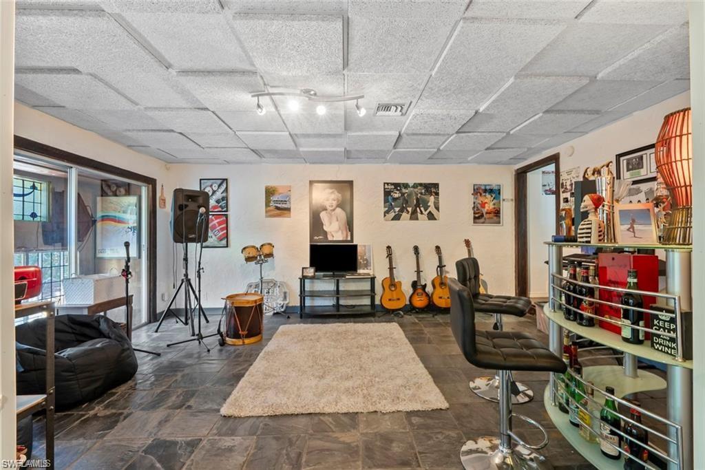 3550 Hazel Road Naples, FL 34104 - Photo 11 of 43 a living room with lots of furniture and a rug