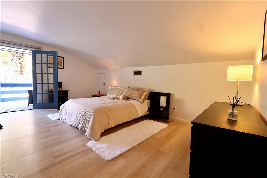 3550 Hazel Road Naples, FL 34104 - Photo 18 of 43 a bedroom with a bed and a lamp