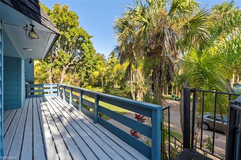 3550 Hazel Road Naples, FL 34104 - Photo 19 of 43 a view of balcony with wooden floor and outdoor seating