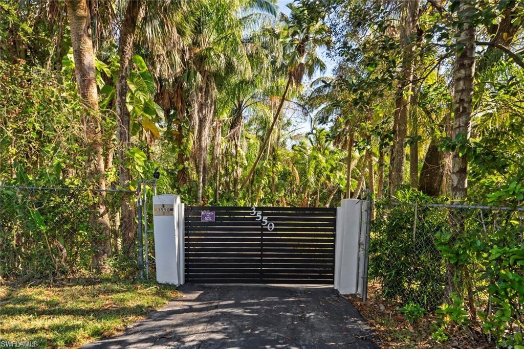 3550 Hazel Road Naples, FL 34104 - Photo 2 of 43 a view of the house and a yard
