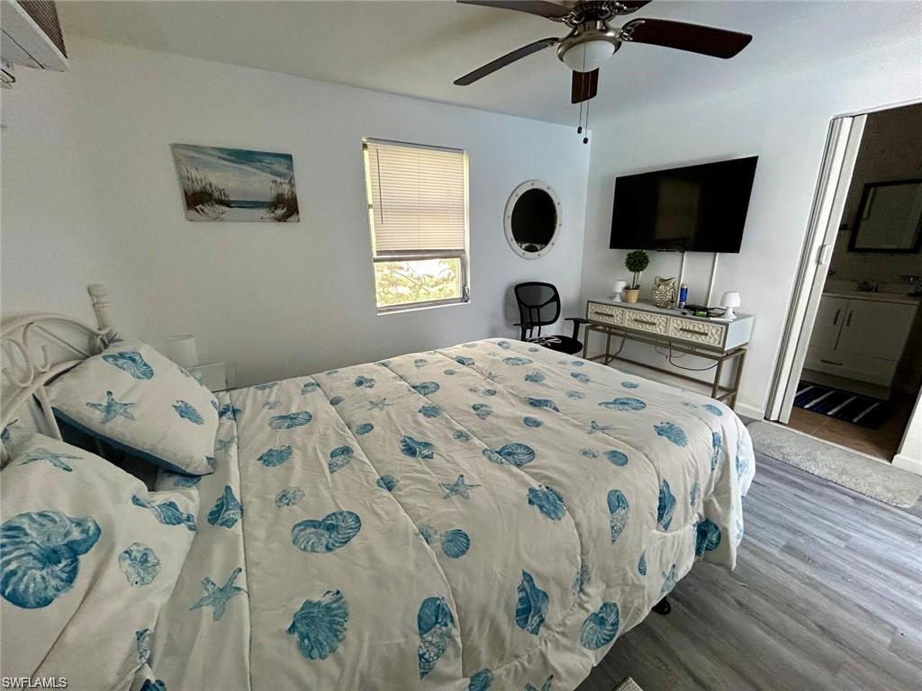 3550 Hazel Road Naples, FL 34104 - Photo 23 of 43 a bedroom with a bed and a flat screen tv