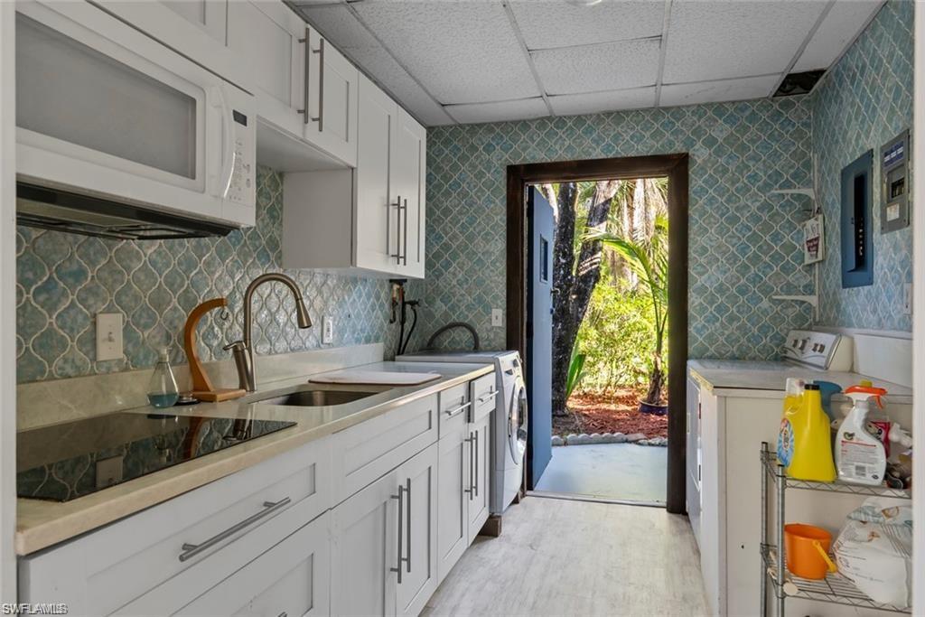 3550 Hazel Road Naples, FL 34104 - Photo 25 of 43 a kitchen with stainless steel appliances granite countertop a sink and a stove next to a window