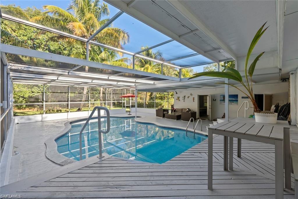 3550 Hazel Road Naples, FL 34104 - Photo 26 of 43 a view of a swimming pool with a patio