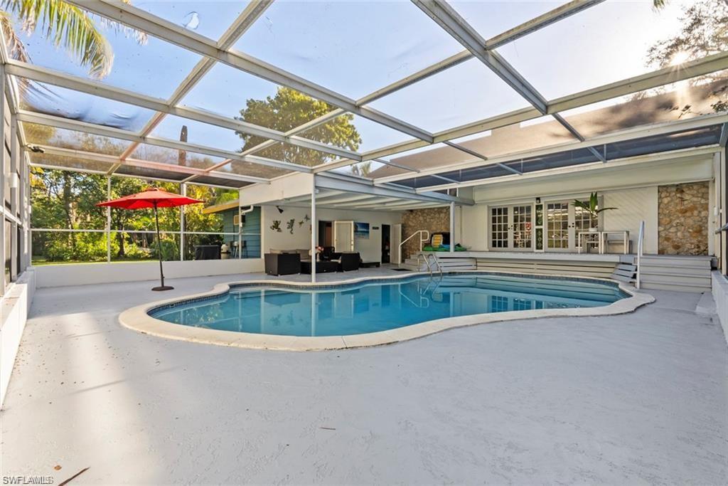 3550 Hazel Road Naples, FL 34104 - Photo 27 of 43 a view of a backyard with a swimming pool