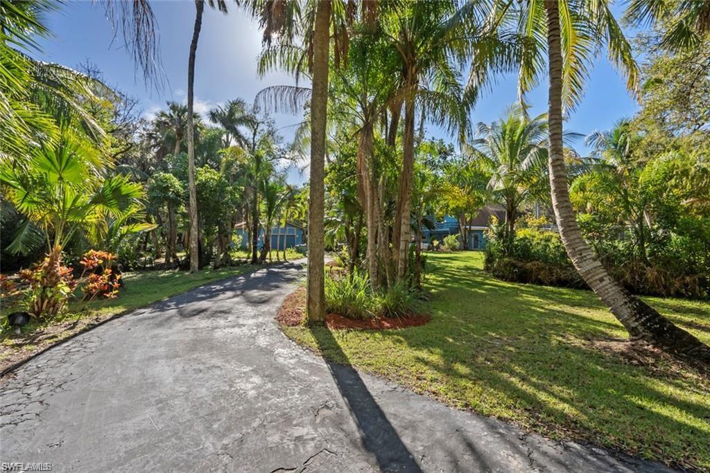 3550 Hazel Road Naples, FL 34104 - Photo 29 of 43 a backyard of a house with lots of green space